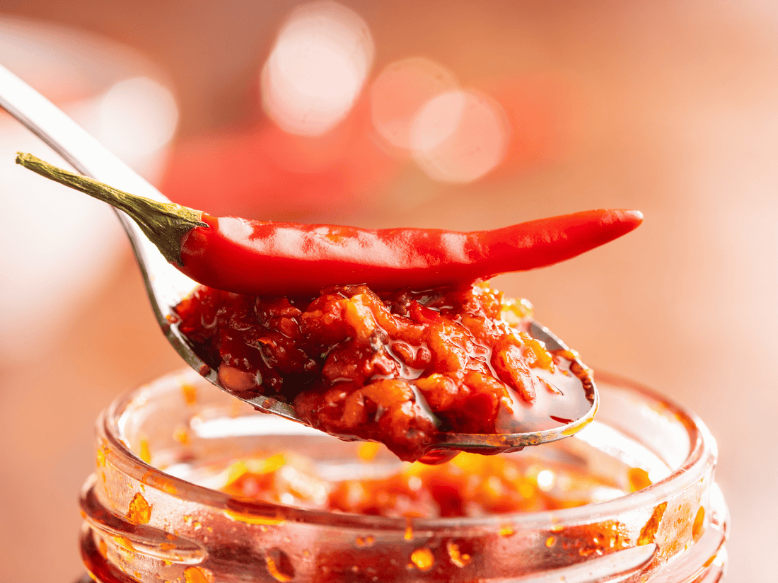 a red chilly pepper laying on a pile of Sachili flavor enhancer